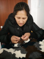 Edith making the finishes of one of our sweaters.
