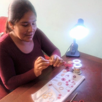 Rosalinda weaving a new design,