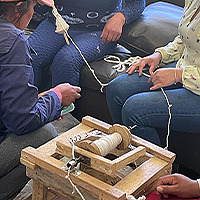 Women Spinning on a Spinning Wheel 