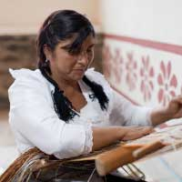 Craftswoman weaving with traditional technique