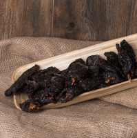 Close-up frontal shot of ancho chili in a recipient.