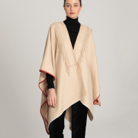 Beige cape with fringes on the neck